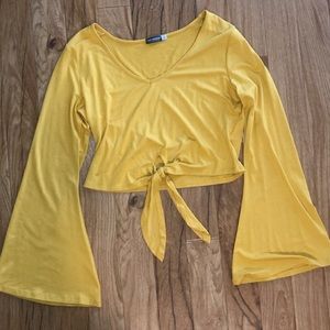 Yellow v-neck tee with tie at the waist.